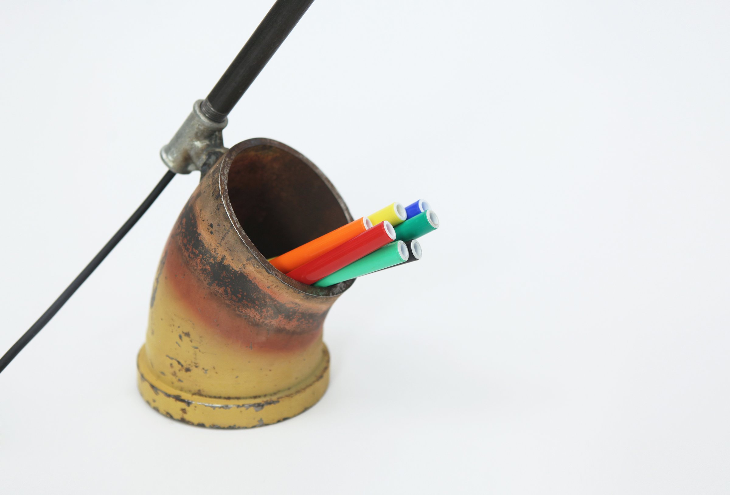 Curva, detail of the galvanised-tube base used as a pen holder