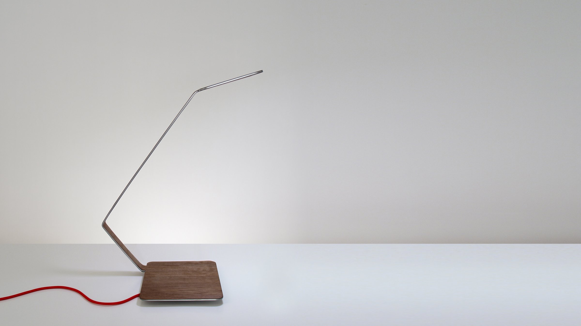 Lanx, OLED table lamp covered in thin sheets of walnut wood