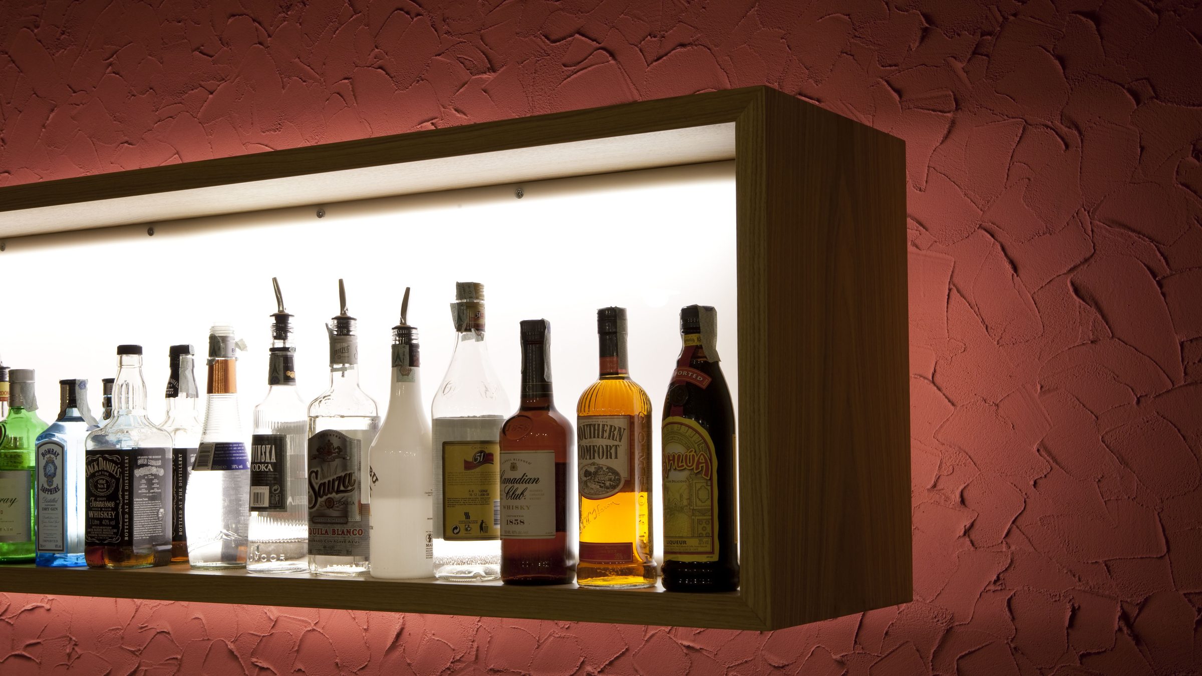 Detail of the backlit bottle rack of the lounge bar