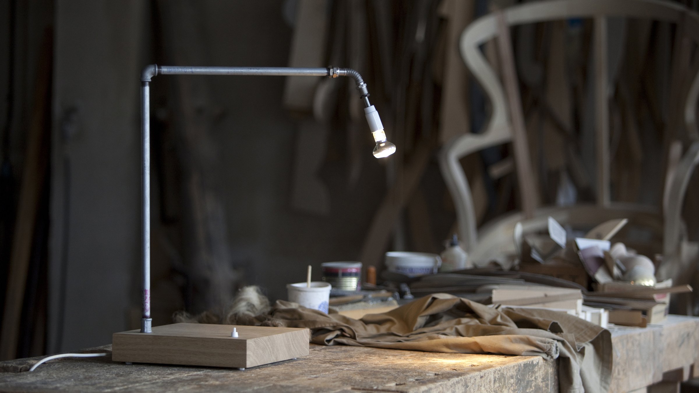 Tubularbells Orientabile, table lamp with a wooden base and adjustable galvanised-tube arm